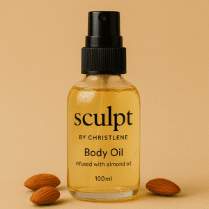 A bottle of Sculpt Body Oil on table surrounded by fresh walnuts on a beige background | Sculpt by Christlene